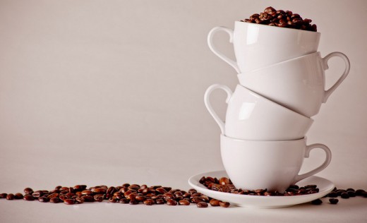 Coffee cups stacked wiht coffee beans